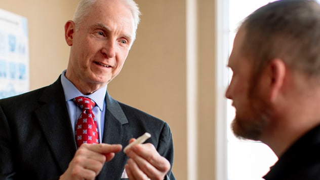 A doctor talks with a program participant about stop-smoking treatment options.